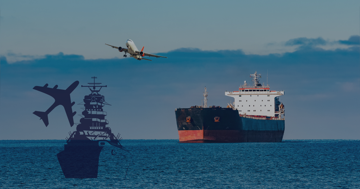 A ship sailing in the ocean while an aircraft flying over.